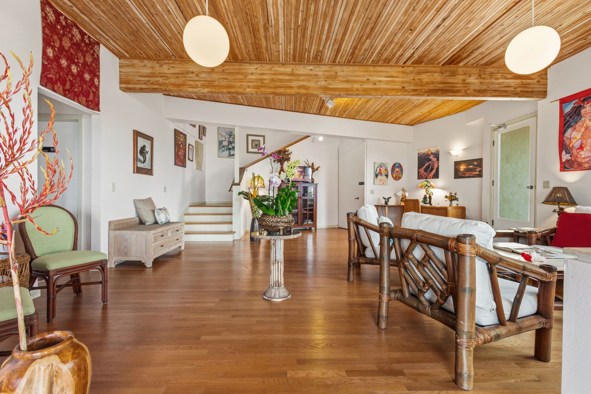 Bright, open living space with wooden ceiling and various decorative elements.